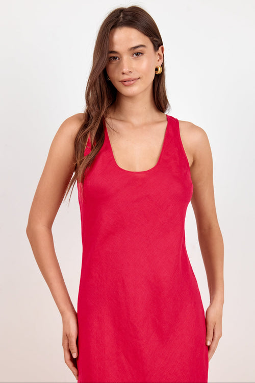 A woman modeling a sleeveless red scoop-neck dress against a plain light gray studio background.