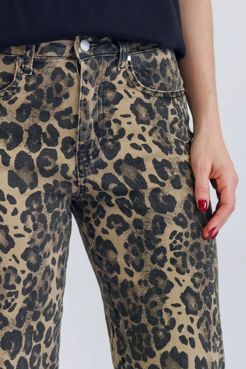 woman wearing high-waisted leopard print jeans paired with a black tee.