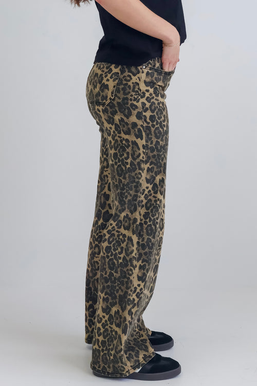 woman wearing high-waisted leopard print jeans paired with a black tee.