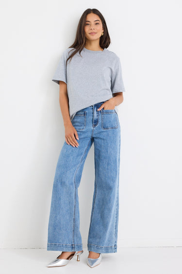 model wears a light blue high waisted wide leg jean