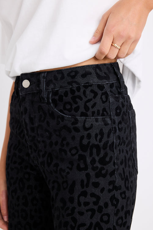 model wearing a black animal jean and white tee