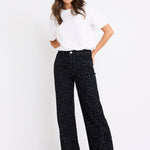 model wearing a black animal jean and white tee