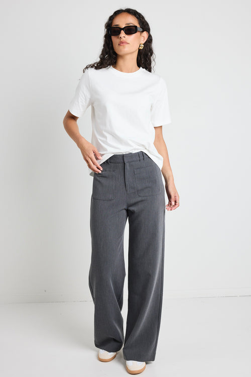 model wears white t-shirt and grey wide leg pants