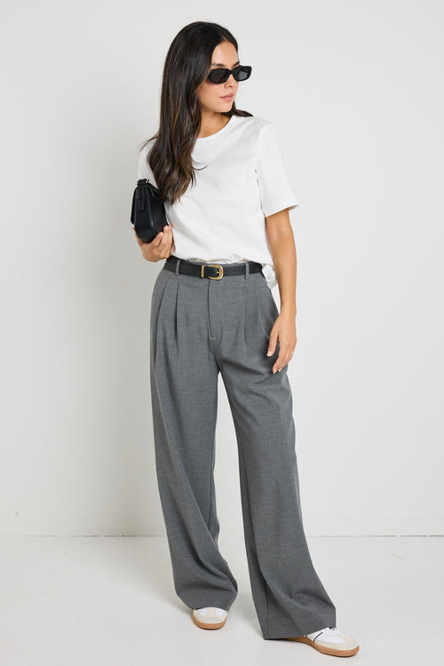 Model wears grey wide leg pants