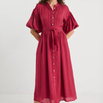 Woman wearing a red dress with puff sleeves on a white background