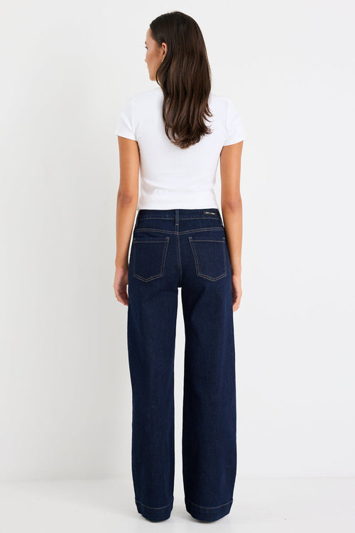 Woman wearing a dark denim jean and white tee