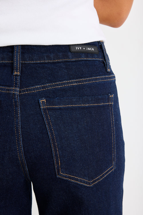 Woman wearing a dark denim jean and white tee