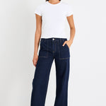 Woman wearing a dark denim jean and white tee