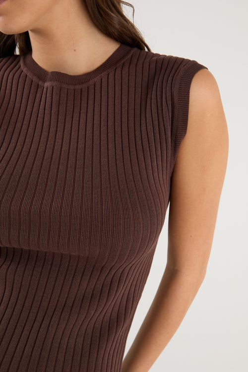 model wears a brown rib knit with blue jeans