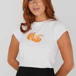 model wearing white crop top tee with an orange on the front and a black skirt