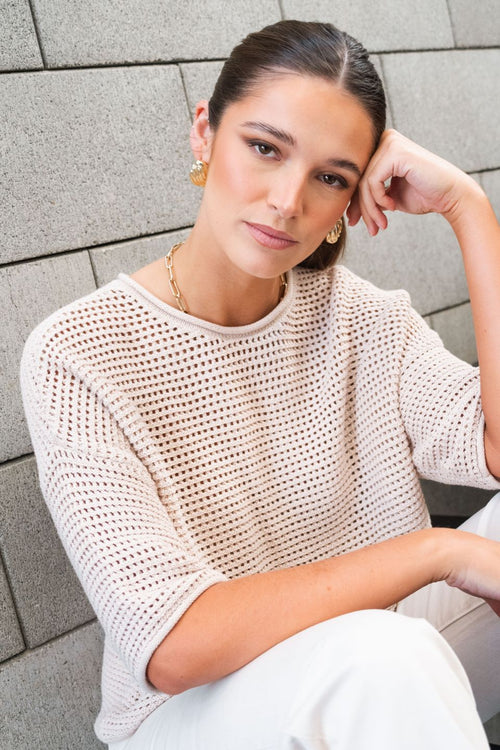 model wears a Beige Crochet Knit Top