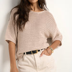 model wears a beige knit t shirt