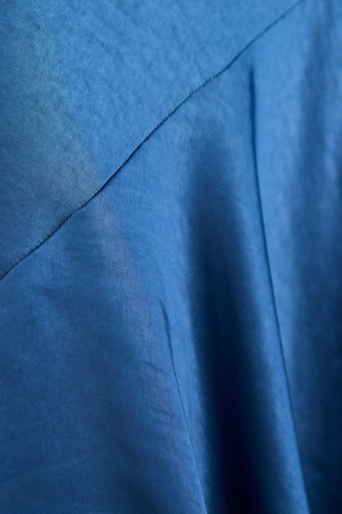 model wears a blue satin maxi dress