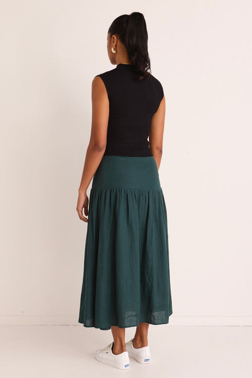 model wears a green linen midi skirt