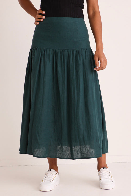 model wears a green linen midi skirt