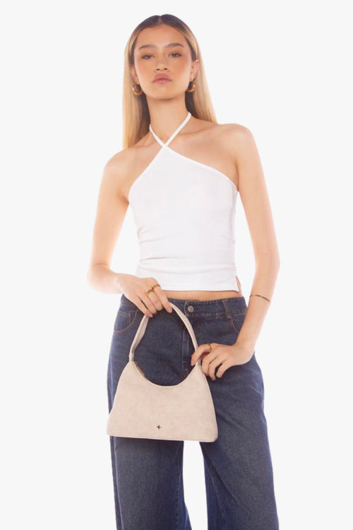Beige faux suede shoulder bag with a minimalist design and single strap handle.