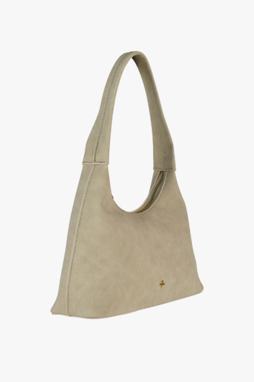 Beige faux suede shoulder bag with a minimalist design and single strap handle.