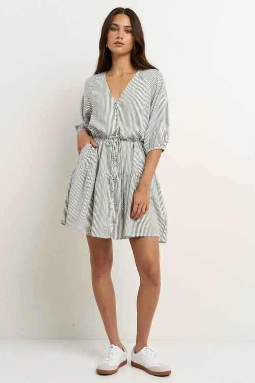 model wears a green and white stripe mini dress