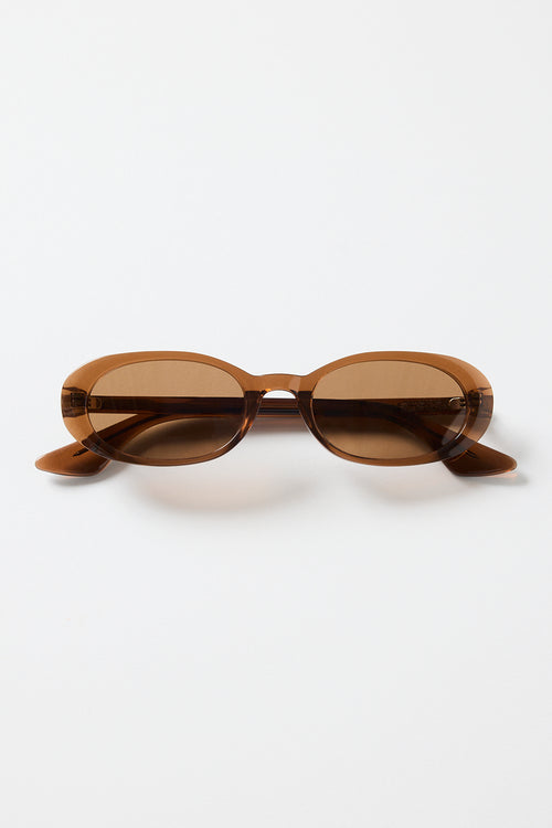 Narrow espresso-brown oval sunglasses with warm brown tinted lenses, photographed against a white background.