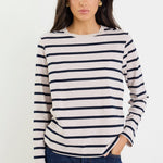 Woman wearing a striped sweater and jeans on a white background