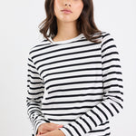 Woman wearing a black and white striped long-sleeve shirt on a white background