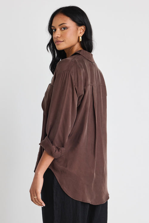 model wears a brown shirt