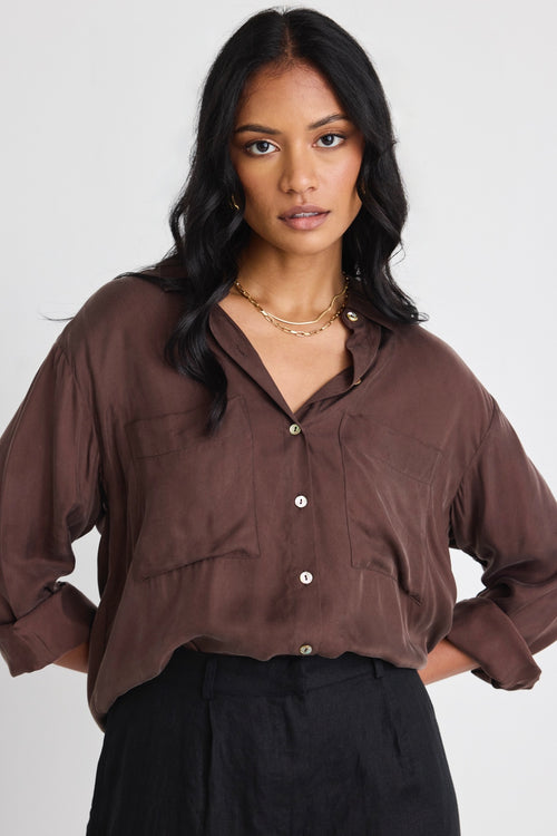 model wears a brown shirt