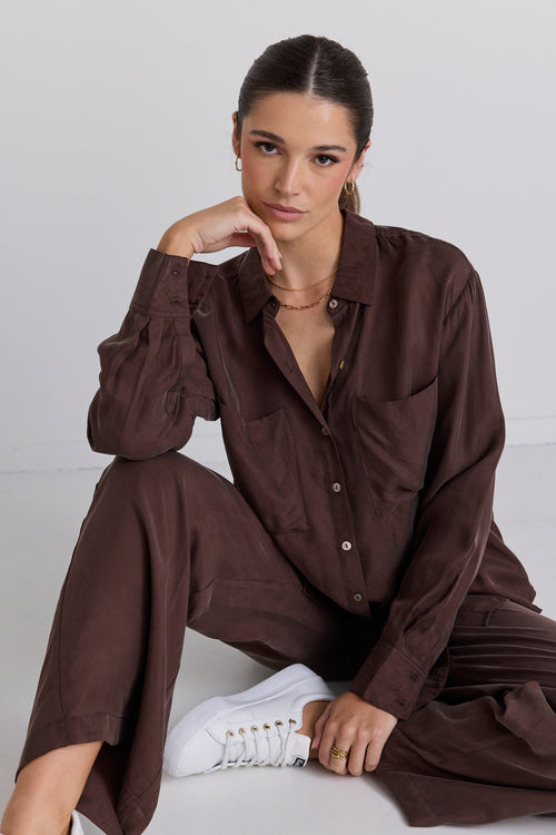 model wears a brown shirt