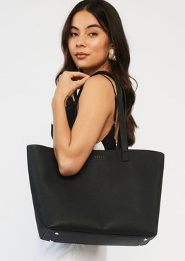 model wears a black tote bag
