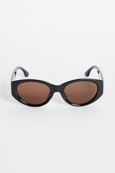 Black sunglasses with brown lenses on a white background