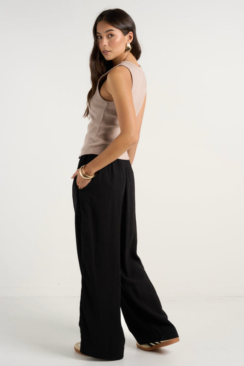 model wears black wide leg pants