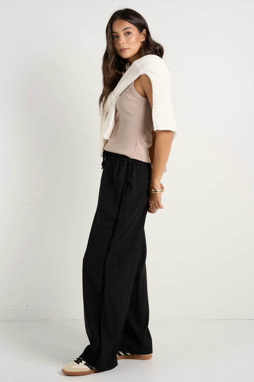 model wears black wide leg pants