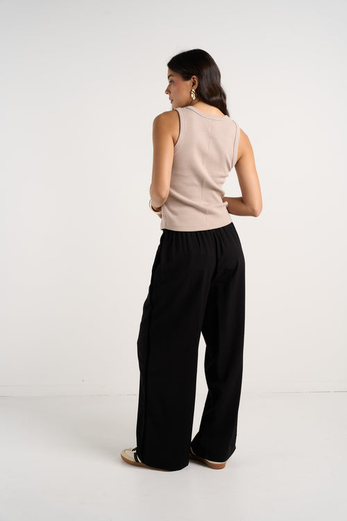 model wears black wide leg pants