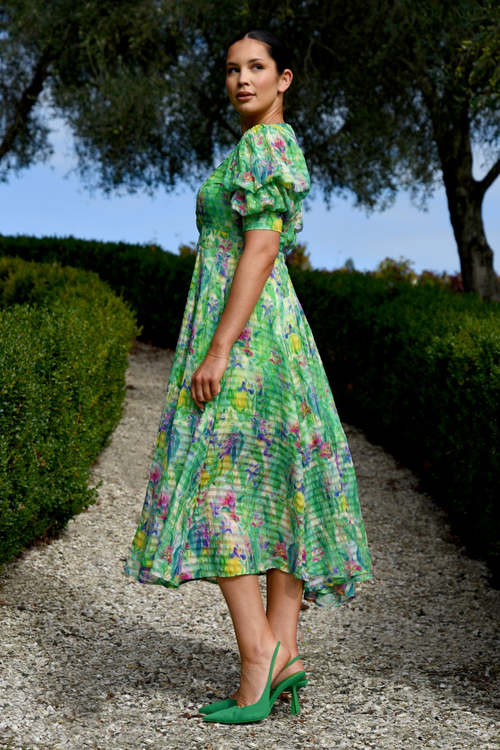 model wears green floral midi dress