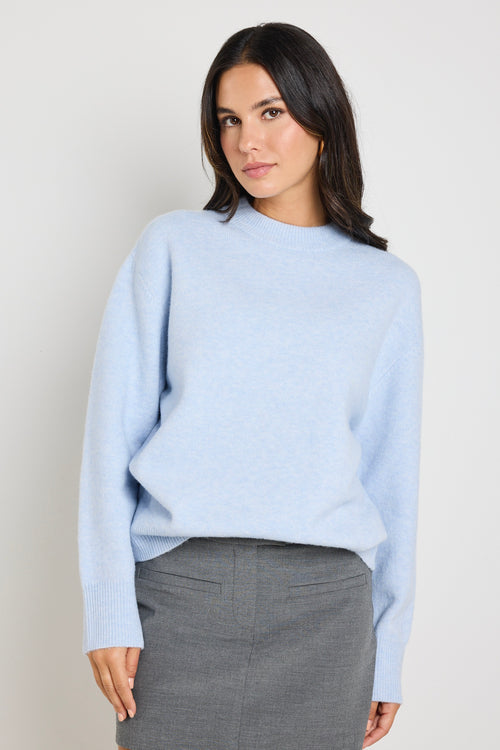 model wears light blue knit jumper