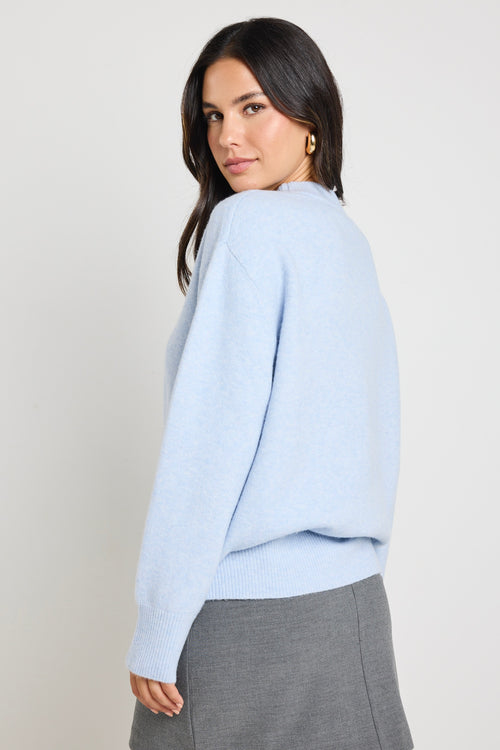 model wears light blue knit jumper