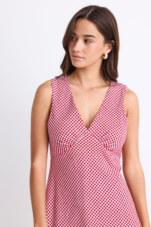 A sleeveless red and white gingham mini dress with a flattering V-neckline. Fully lined for comfort, made from 100% Cotton for a breathable, natural feel.