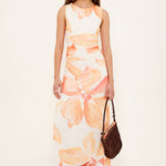 woman wearing a peach shirred midi dress