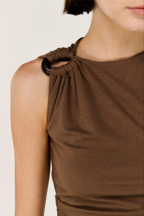 Brown sleeveless top with a knot detail on a neutral background