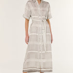 Woman wearing a patterned dress on a white background