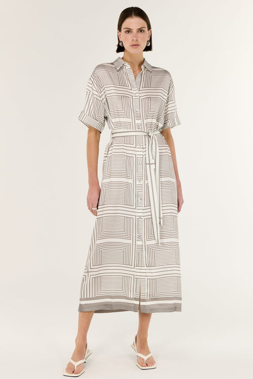 Woman wearing a patterned dress on a white background