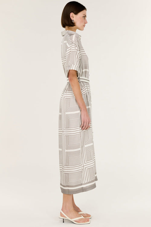 Woman wearing a patterned dress on a white background