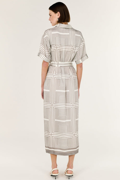 Woman wearing a patterned dress on a white background