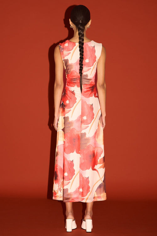 Woman wearing a floral dress with a red background