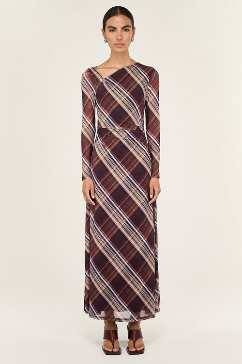 Woman wearing a plaid dress on a white background