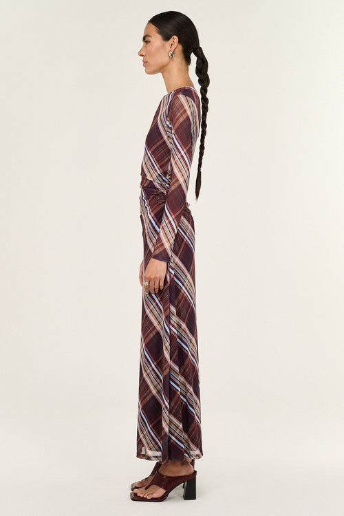 Woman wearing a patterned dress on a white background