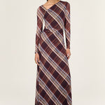 Woman wearing a plaid dress on a white background