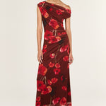 Woman wearing a red floral one-shoulder dress on a white background