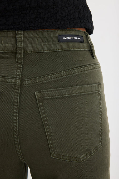 Woman wearing khaki jeans and a black top