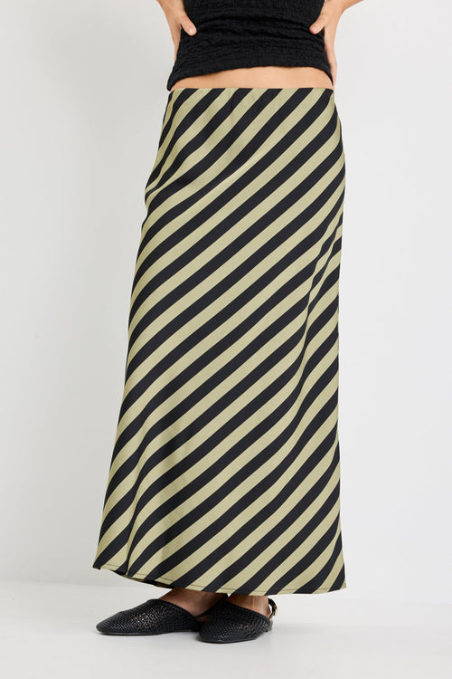 model wearing a silky green black stripe skirt